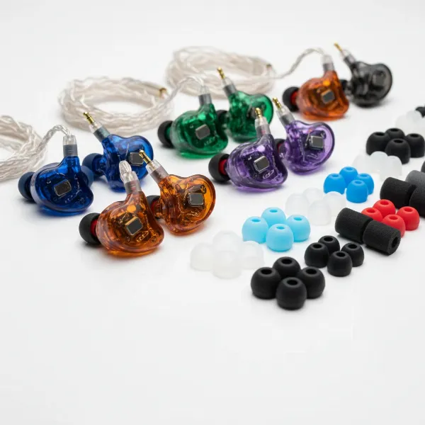 A selection of universal in-ear monitors (UIEMs) with various silicone and foam ear tips displayed, illustrating their interchangeable nature and broad compatibility.